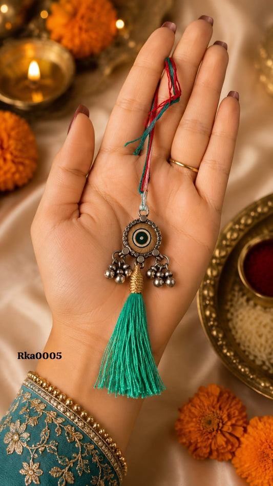 Evil Eye Silver Rakhi with green tassel