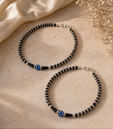 Anklet with black beads and single evil eye bead