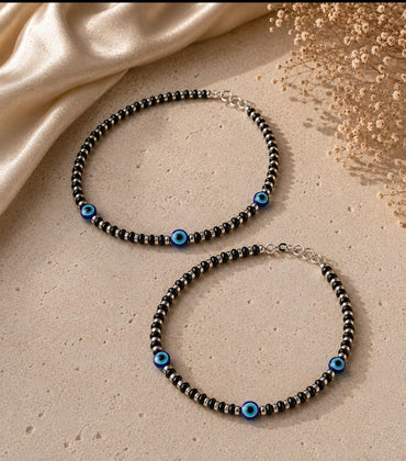 Anklet with black beads and multiple evil eye beads
