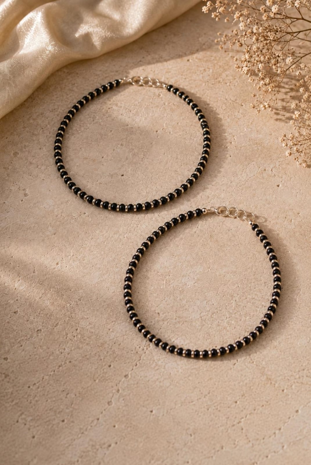 Anklet with black beads separated by silver spacers