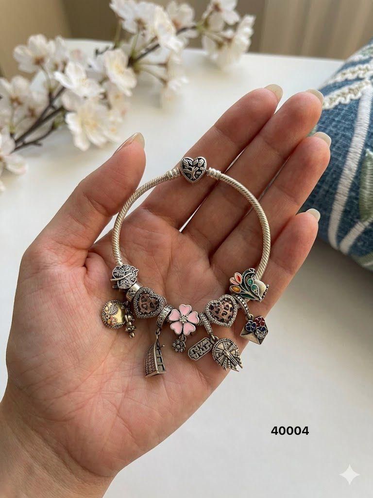 92.5 Sterling Silver Charm Bracelet – pink enamel florals, pink heart, and intricate Star Wars dangles.
