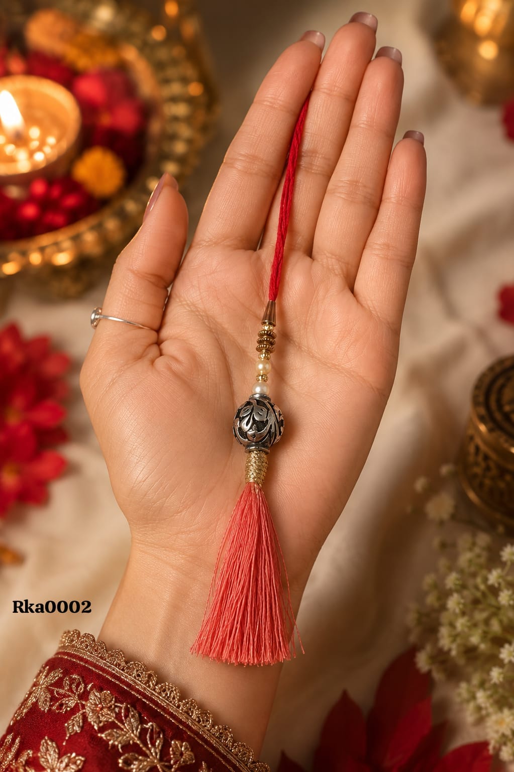 Beaded Silver Rakhi with red tassel