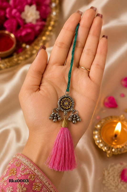 Floral Silver Rakhi with pink tassel