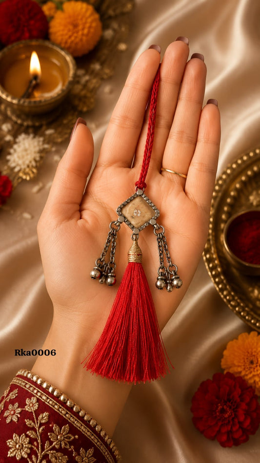 Geometric Silver Rakhi with red tassel