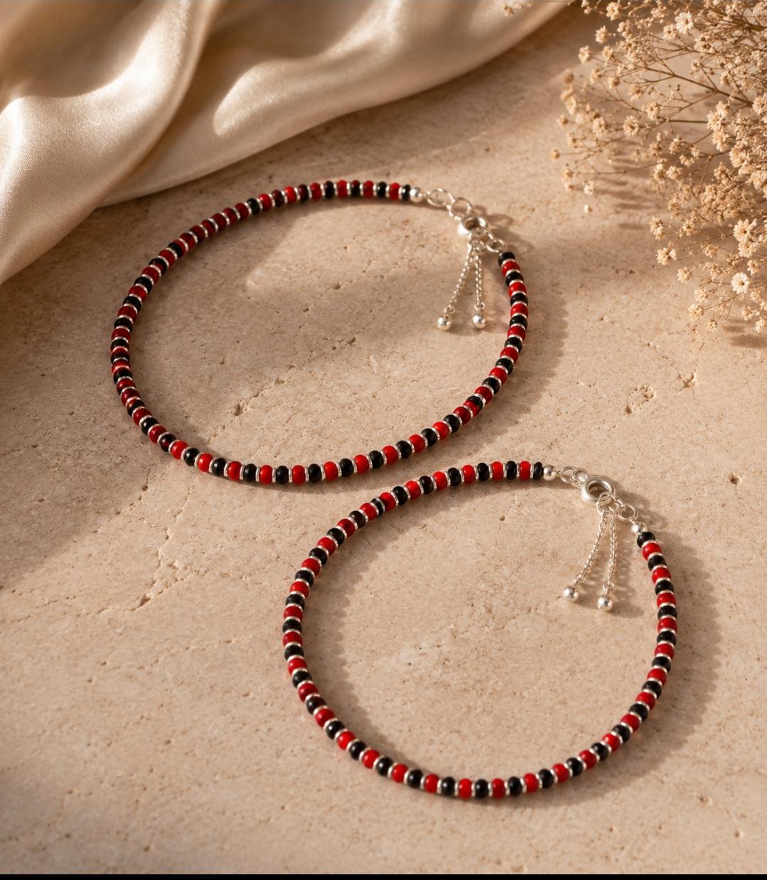 Anklet with red and black beads with silver spacers