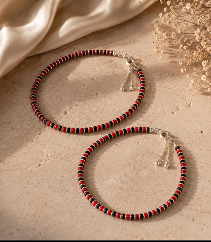 Anklet with red and black beads with silver spacers