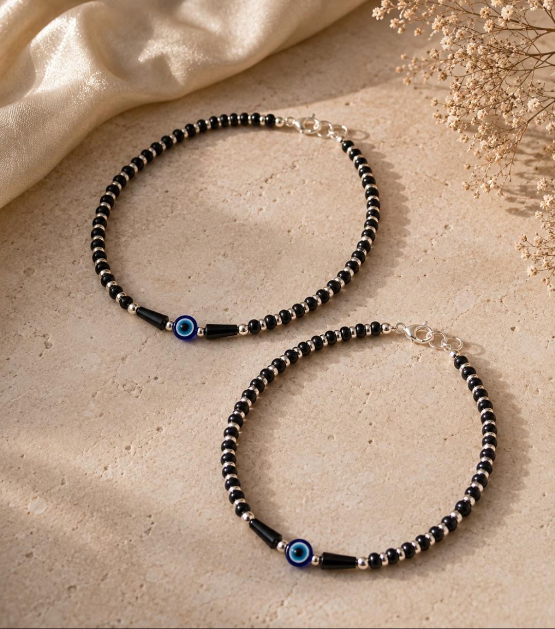 Anklet with black beads and single evil eye bead