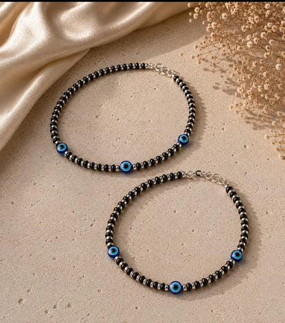 Anklet with black beads and multiple evil eye beads